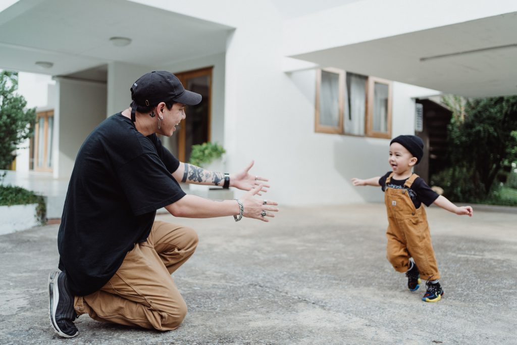 Dad carrying baby in kitchen